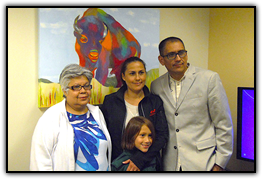 Arturo Garcia (far right) and his family with one of the paintings he donated to the Cancer Center during a reception May 26. Left to right: Garcia’s mother, Maria Torres; wife Erika Tejeda; son Arturito